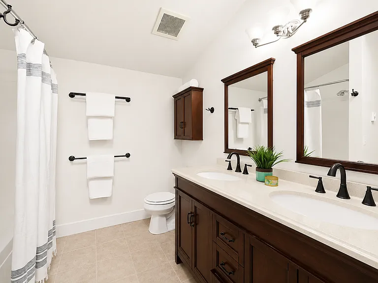 Bathroom with double vanity and bathtub