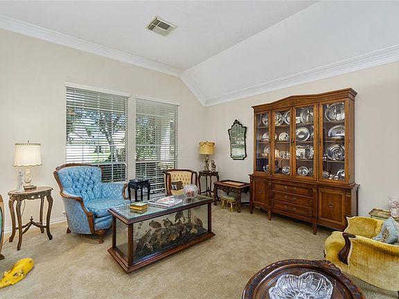 The living room has a neutral tone, high ceilings and light and bright.