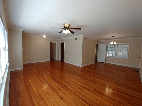 Large living room with dining area between the kitchen and laundry room