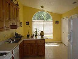 Eat-in kitchen with tile floors, vautled ceilings, oak cabinets