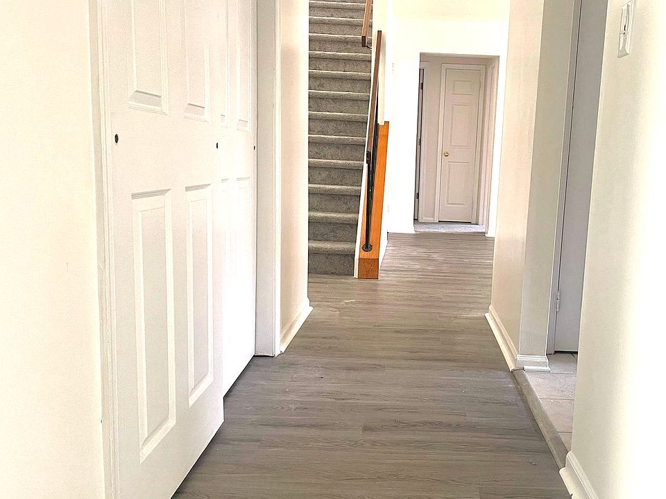 Entrance hallway. 
closet to left, kitchen to right. 
master bathroom and bedroom straight ahead
living area and balcony 

next level stairs