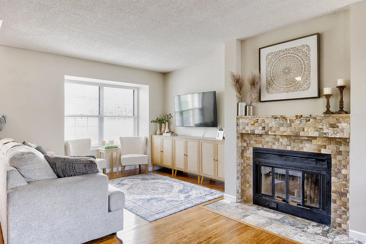 Cozy up by the fireplace in the spacious living room_perfect for relaxing or entertaining - 1818 S Quebec Way #16-6