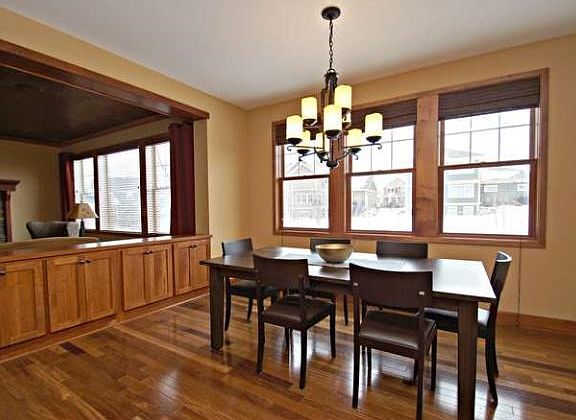 The dining area is adjacent to the kitchen and living area with access to the screened porch and fenced back yard.