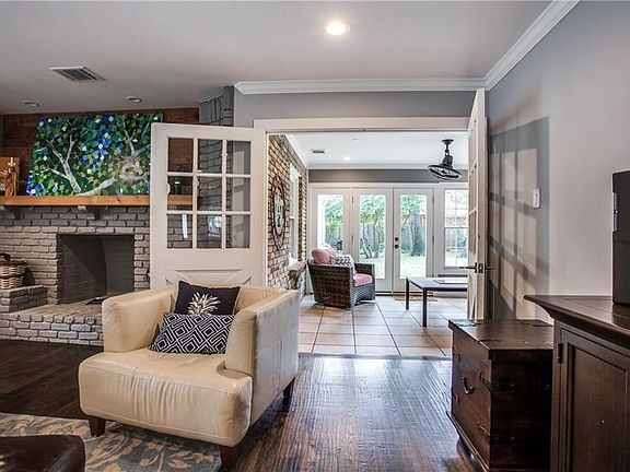 Warm hardwood flooring and updated lighting throughout the first floor. The decorative fireplace and french doors area a nod to the original construction in this Richardson neighborhood that has become one of the the "hottest" real estate markets.