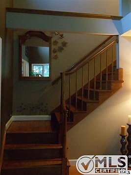 Open wood staircase to second floor of the home.