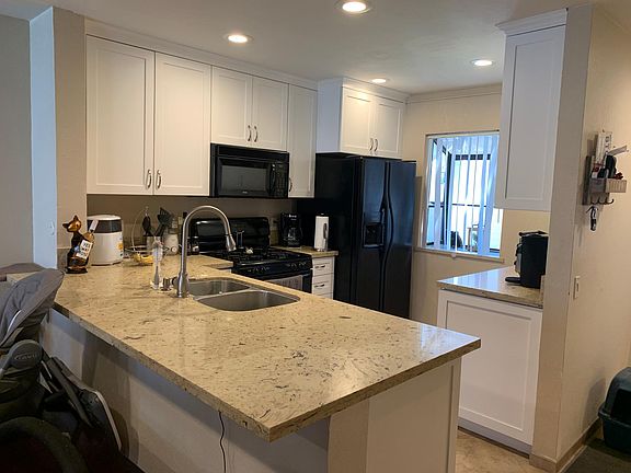 Kitchen view, this refrigerator has been replaced by a stainless steel one.