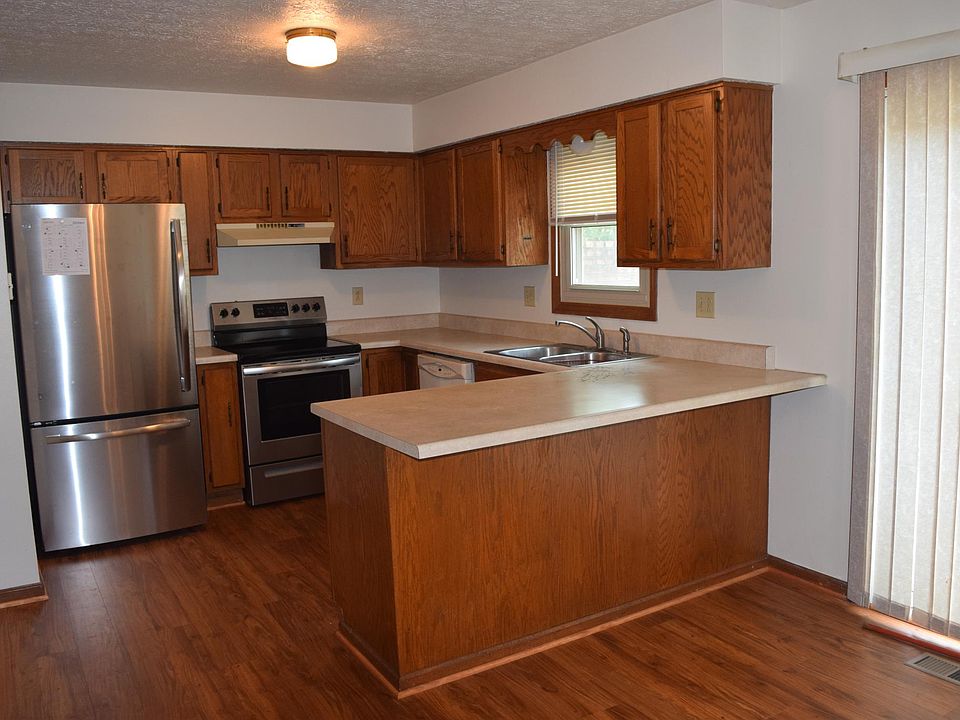 The new refrigerator has 24.1 cubic inches of space, and the stove has a self cleaning oven. The breakfast bar will accommodate 3-4 stools. The pantry is to the left. The dining area behind the cameraman has sliding doors to the patio.