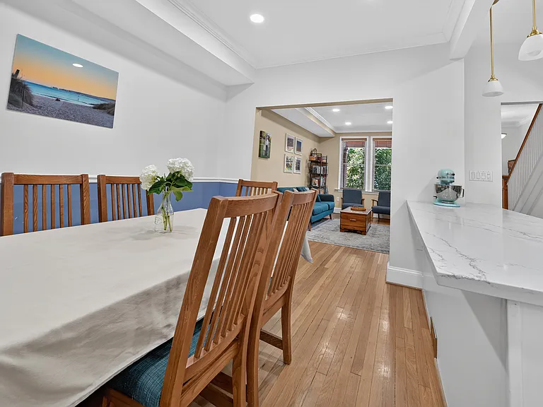 Dining room with an open plan to the kitchen (not pictured, to the right), looking back towards the front of the home