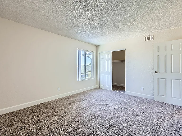 Step into serenity with this beautifully lit bedroom, perfect for relaxation.
