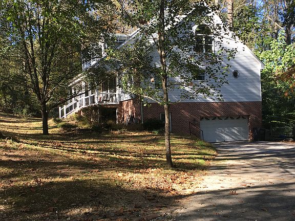 View of side of home, two car garage doors under home from driveway
