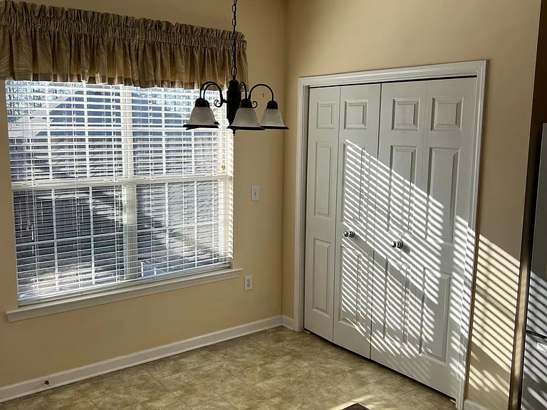 Eating area in kitchen and laundry closet.