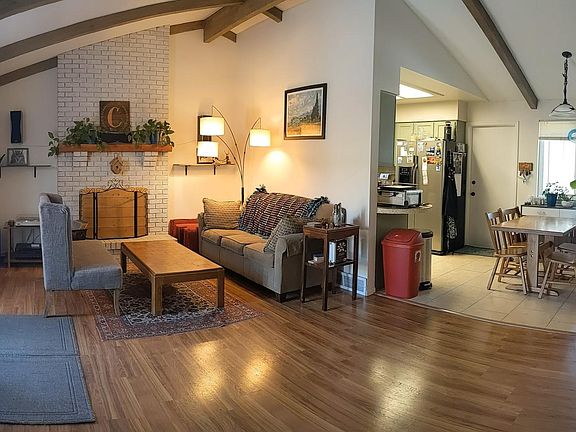 Enter the main floor and be greeted by a quaint whitewashed brick fireplace and vaulted ceilings. The kitchen and dining area are also on the main floor!
