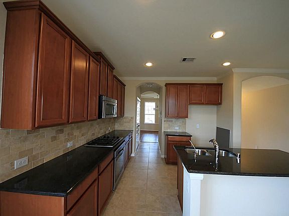 Kitchen features granite counter tops, 42 inch cabinets and