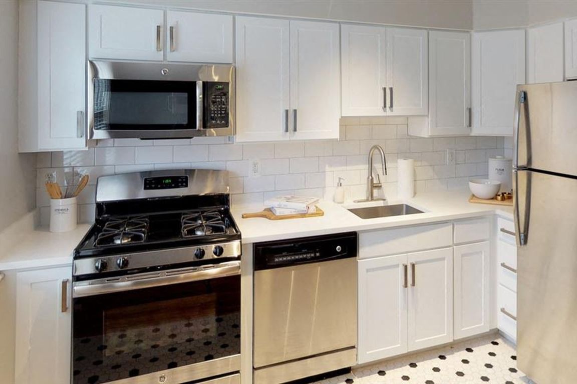 Tiled kitchens with sleek cabinetry