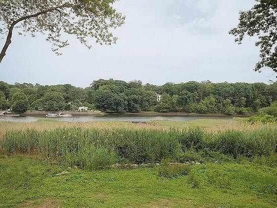 View from large deck out of living room. Outdorr table and c