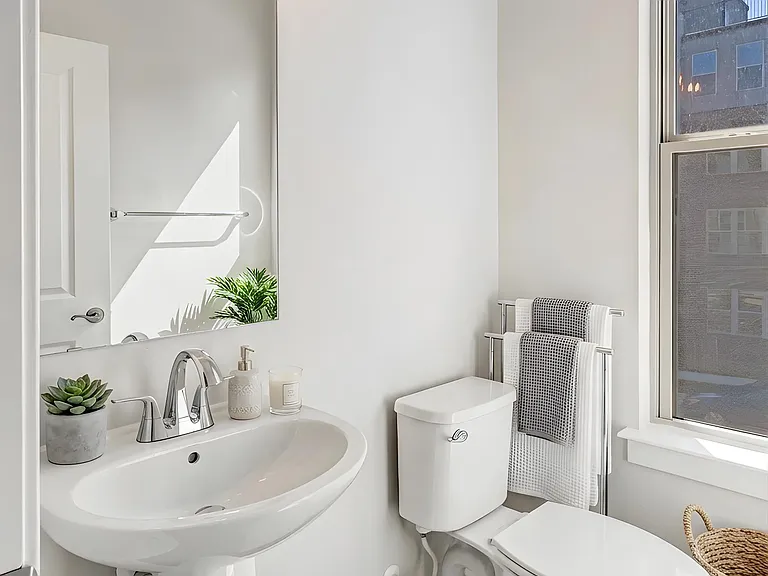Convenient main-level powder room thoughtfully located for guests and everyday use. Virtually staged.