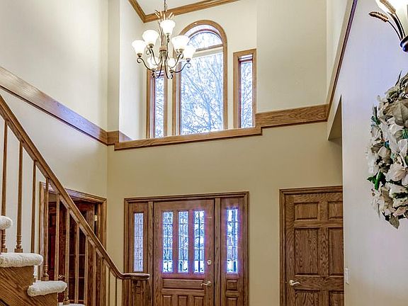 Your guests will open the front door and will see this dramatic two story foyer with oak crown moulding.
