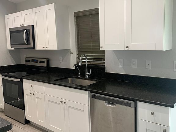 Modern granite kitchen facing out to back yard
