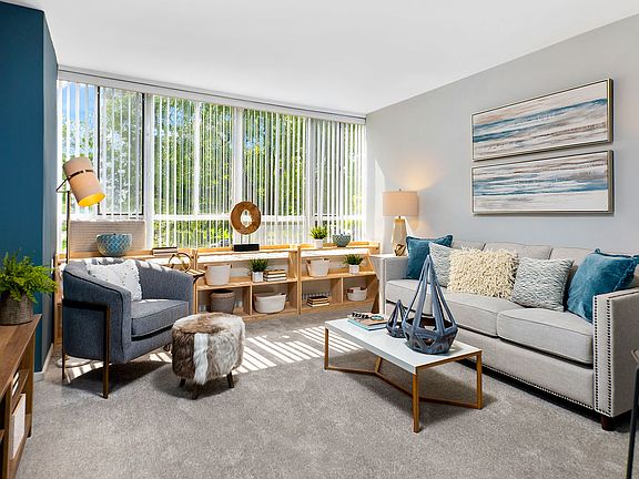 You'll find plenty of space to stretch-out, relax and enjoy the park views in this living room in our 1-Bedroom Alden floor plan.