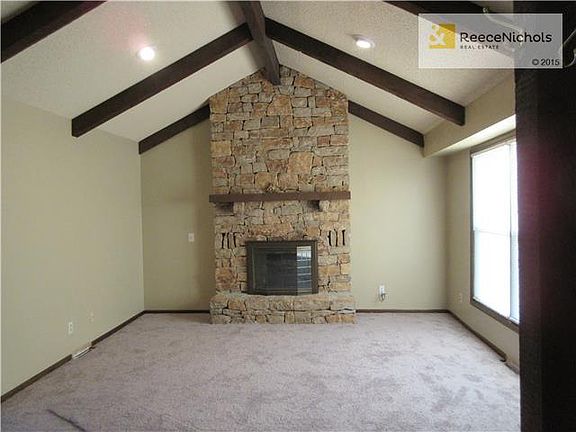 Great room boasts vaulted ceilings and stone fireplace.