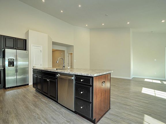 Kitchen island overlooking large family room with vaulted ceilings