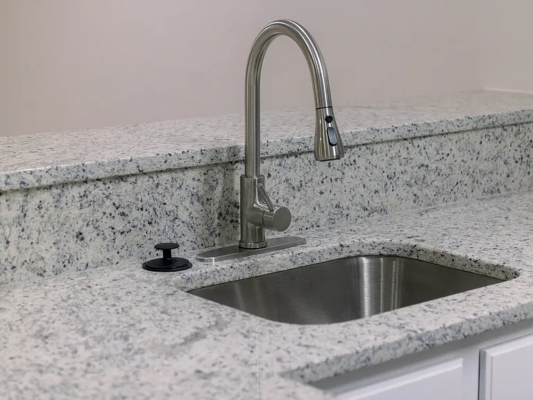 The raised backsplash allows for an additional seating area around the perimeter of the kitchen.