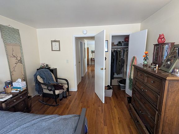 bedroom showing hallway to bathroom and living room