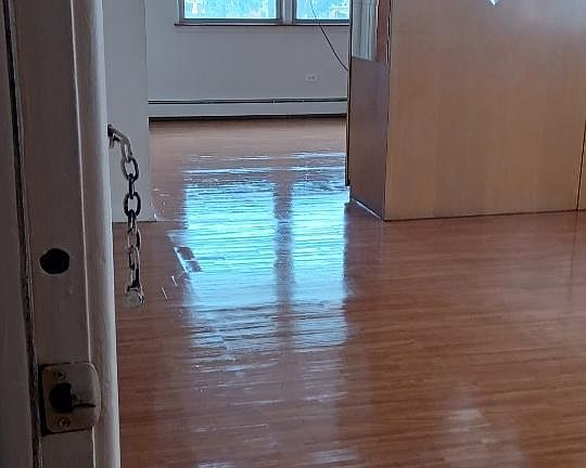 Very large living area with storage closet diving the room.