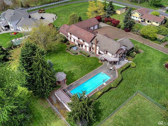 2.4 acre parcel located in an ultra desirable Edgewood location. The beautifully manicured resort-like property offers lush greenery, pastures, barn, pool, gazebo and athletic court. 