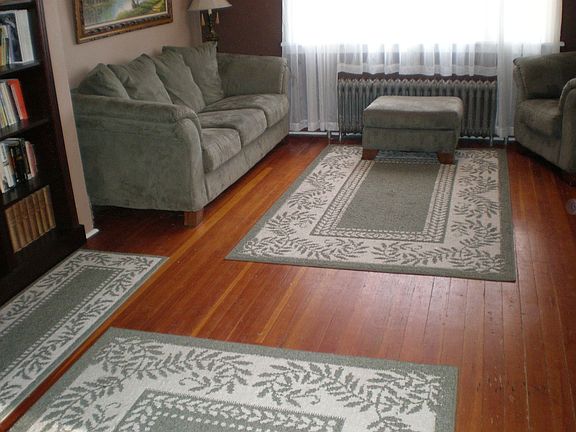 The living room is large with wood floors, and warm paint.