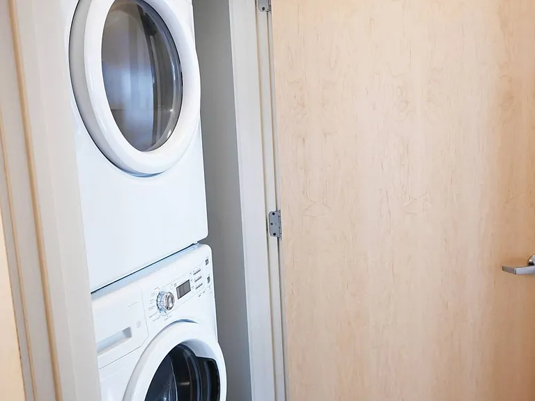 Stacked washer and dryer in a unit at The Sawyer.