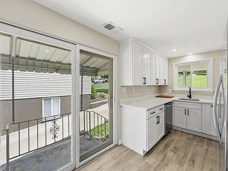 Off the kitchen is a sliding door that will take you to the covered side porch.