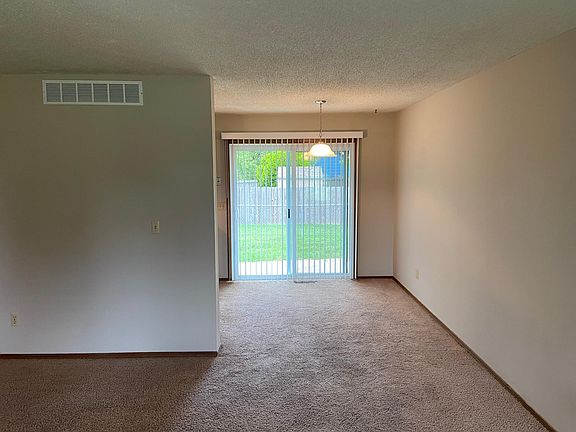View of dining room looking out to fenced back yard