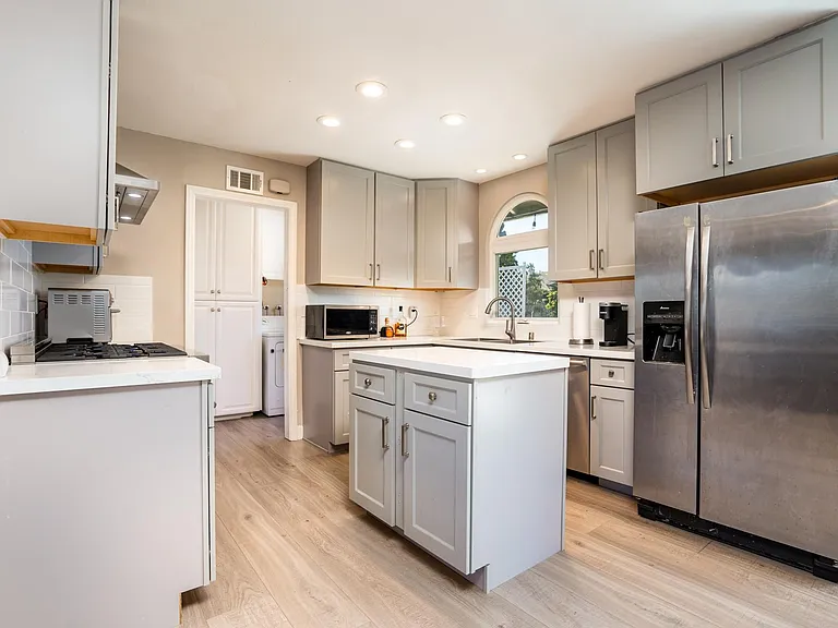 Remodeled kitchen with new cabinets, countertops, and island.