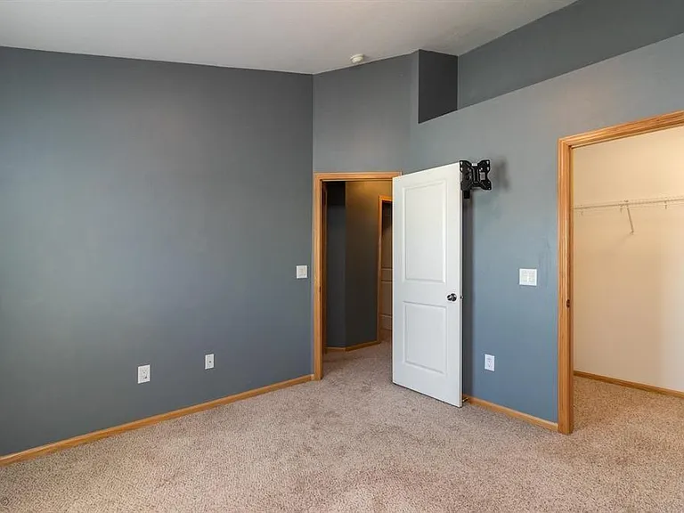 Bedroom w/o furniture. King and queen beds both fit nicely. Closet and ledge with outlet.