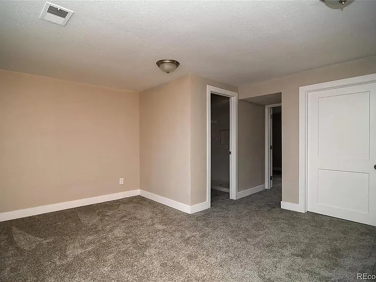Basement living area. Behind the closed door is the laundry room.