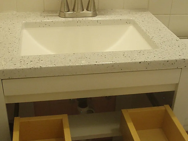 New vanity and faucet as well as new plumbing underneath.