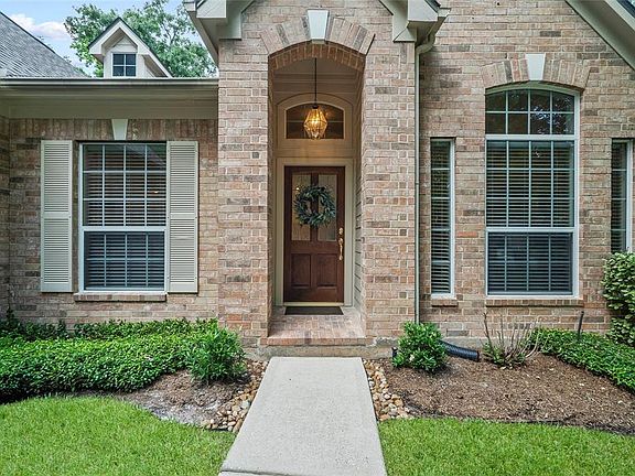 Lovely wood and glass door and covered porch to greet family and friends.