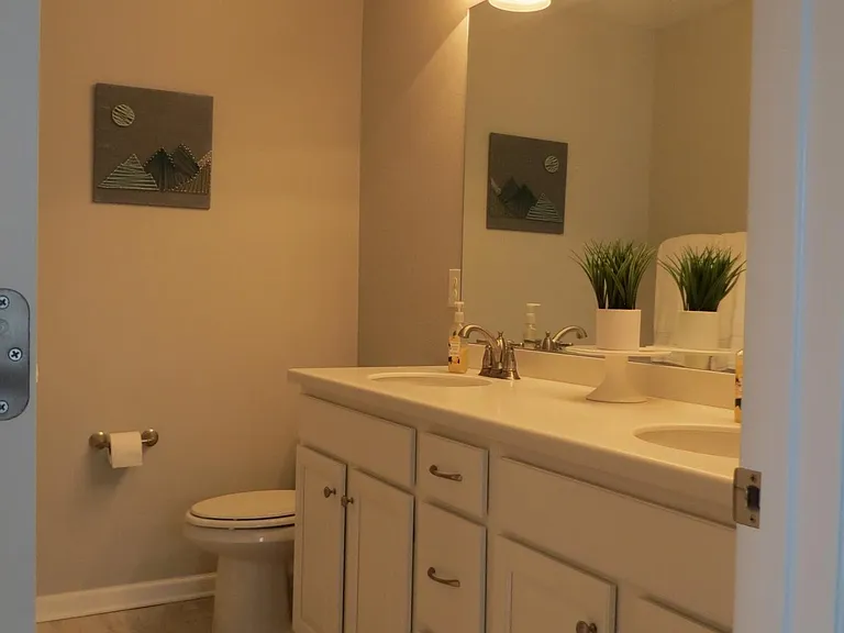Upstairs hallway bath with dual sinks, shower tub combo