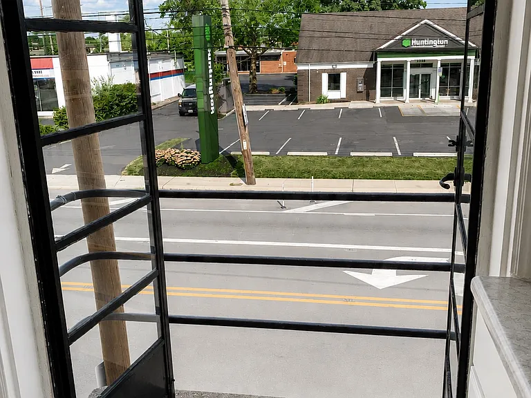 The balcony overlooks the bank and the cutest local florist shop.
