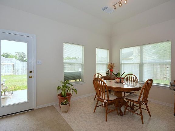 A kitchen with lots of windows and light! Plenty of room for dining too!