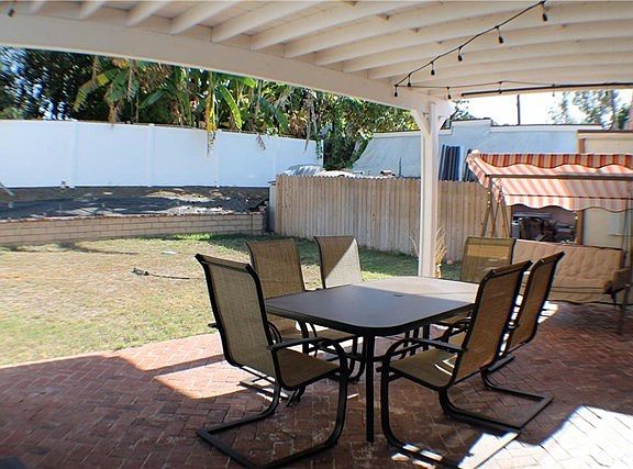 Covered Patio with Brick Floor Tile. Perfect For Family and Friends Gatherings