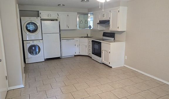 Includes stackable washer/dryer, refrigerator, dishwasher and flat-top stove.