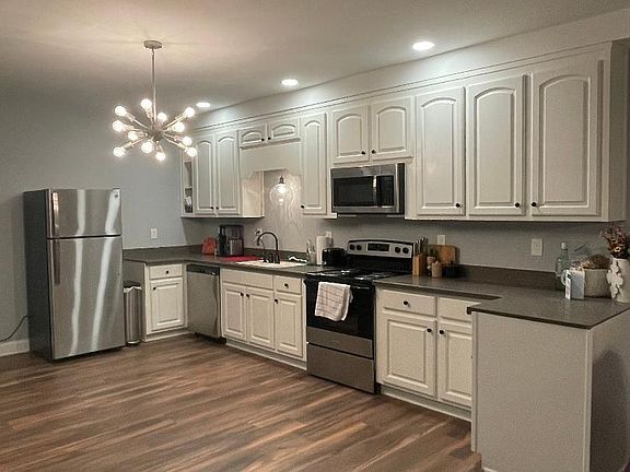 Full size kitchen - wood cabinets corian countertops, and stainless steel appliances.( 30x82- stainless steel island/ prep table coming soon)