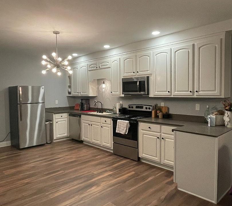 Full size kitchen - wood cabinets corian countertops, and stainless steel appliances.( 30x82- stainless steel island/ prep table coming soon)