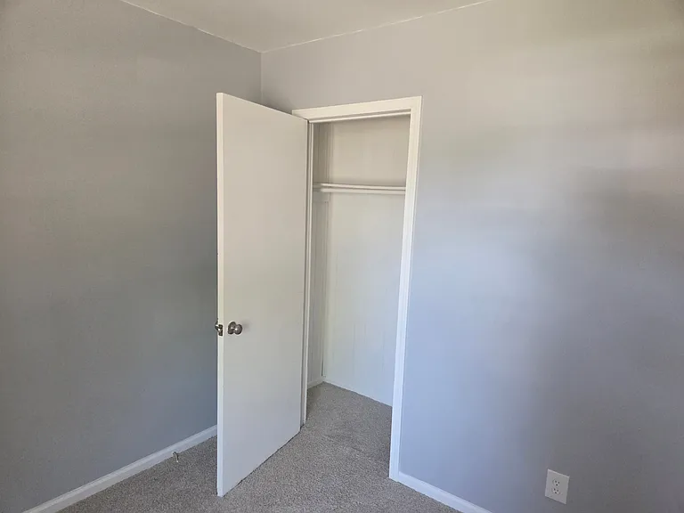 Convenient bedroom closet offering dedicated storage space for clothing, shoes, and personal belongings. Featuring a clean interior, built-in hanging rod, and easy access from the bedroom, this closet helps keep the space organized and clutter-free while