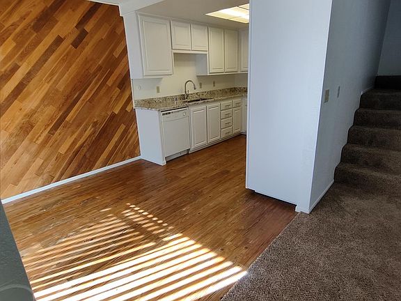 Carpeted stairs and living room.