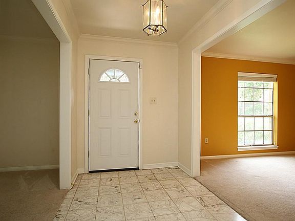 Walk in the front door & you immediately notice how spacious and light the front rooms are. The Formal Living/ Library/ Office is to your right & the Formal Dining room to your left, The front door view is a gorgeous manicured neighborhood with trees