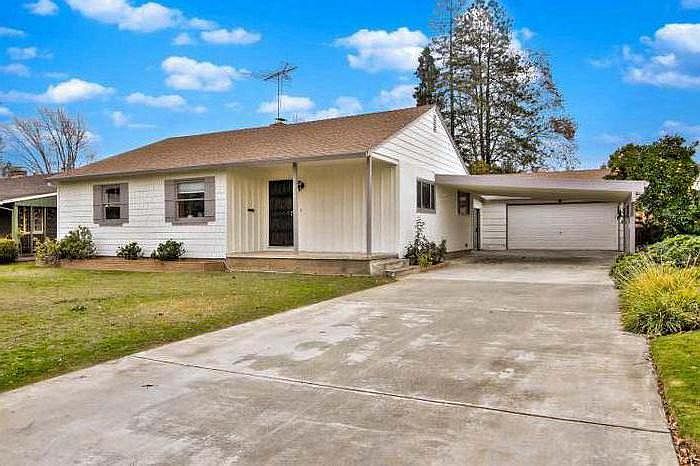 Long driveway leading up to carport and two car garage 