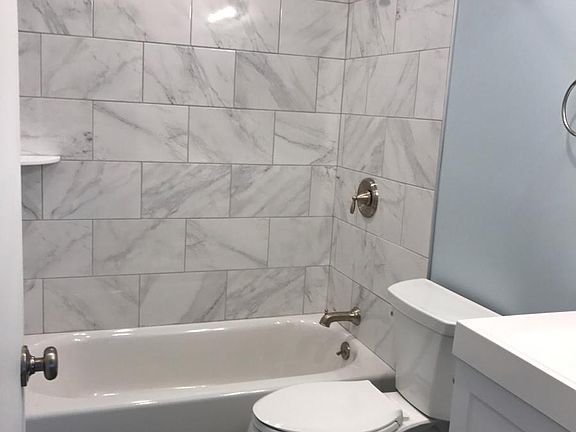 Brand new bathroom with bathtub/shower combo connected to Be